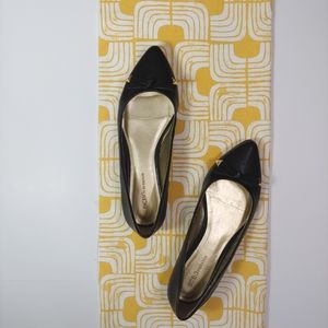 BCBGGeneration black flats with bow detail and gold embellishments.